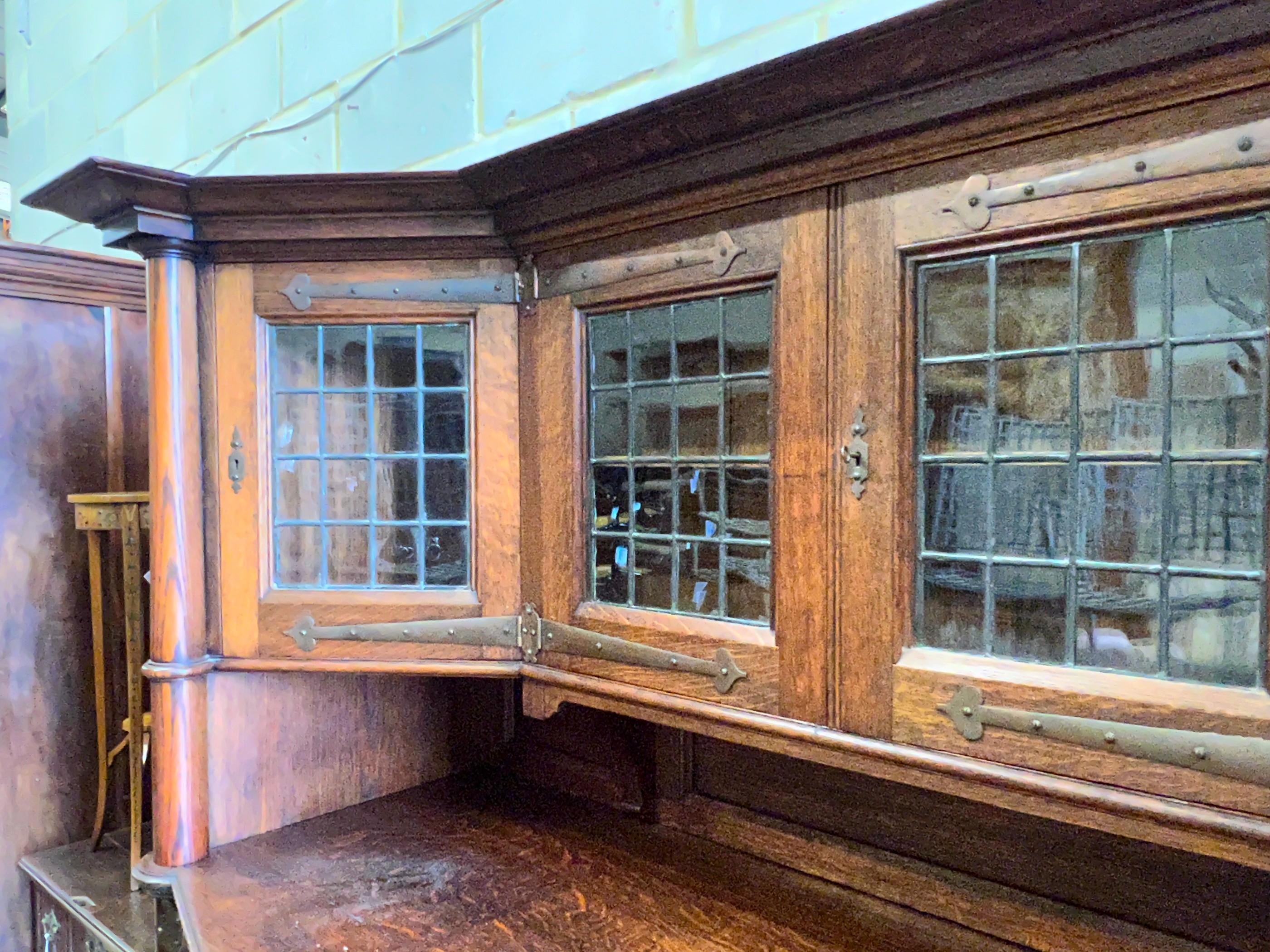 An early 20th century Arts & Crafts copper mounted oak sideboard in the manner of Shapland and Petter, stamped Warings, Oxford Street, London, length 168cm, width 64cm, height 180cm